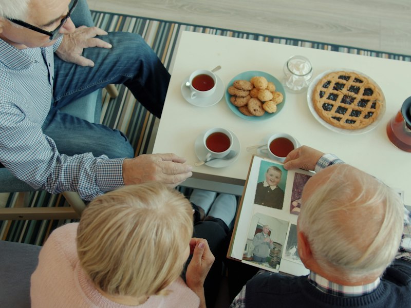 Looking through a family photo album over a cup of tea