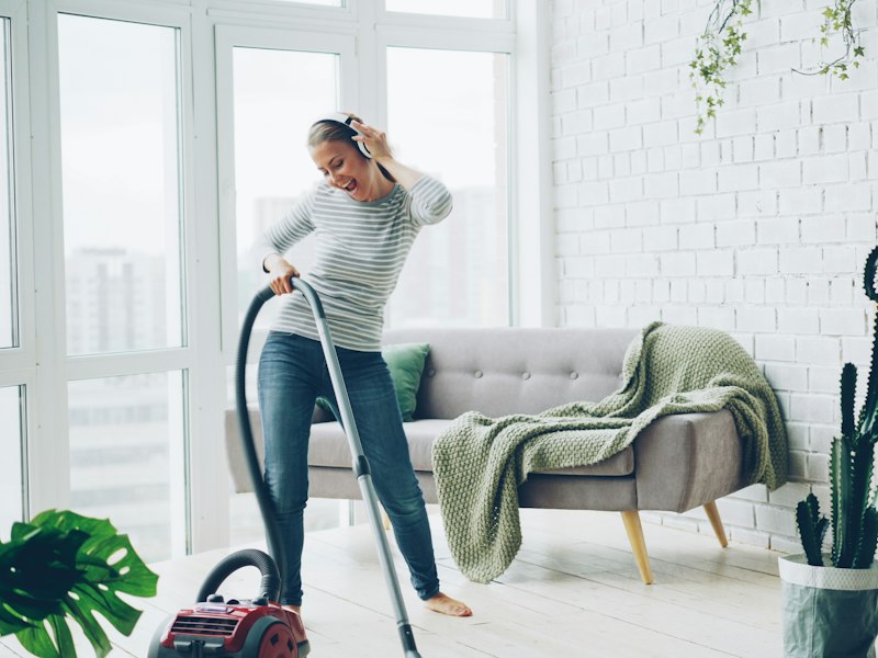 Vacuuming a bright, tidy living room